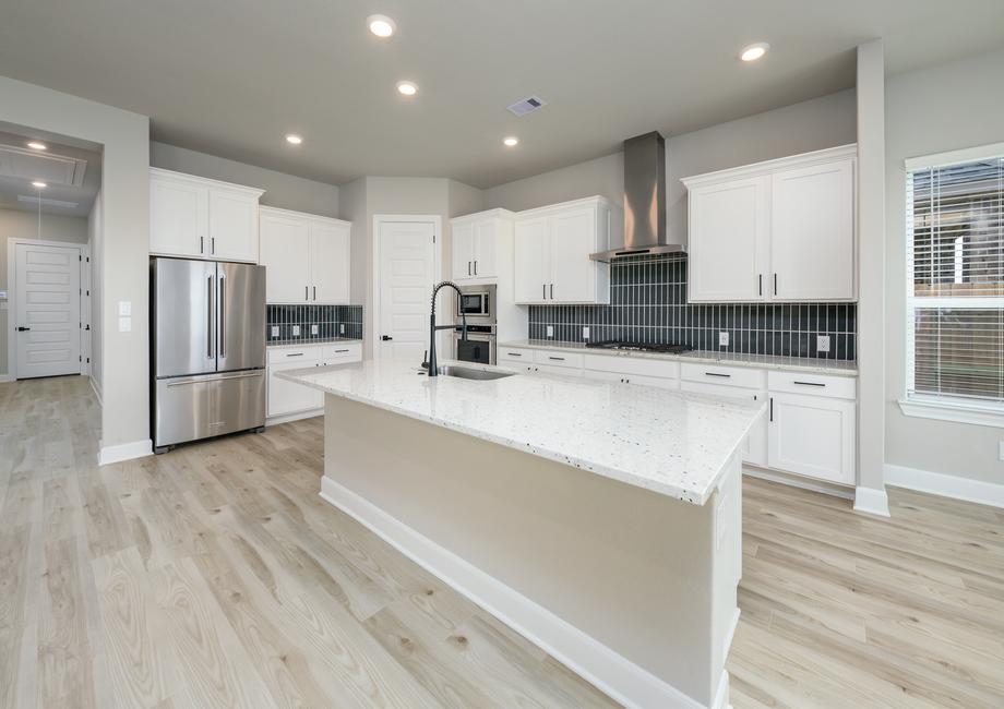 The oversized granite island is the shining star of the kitchen.