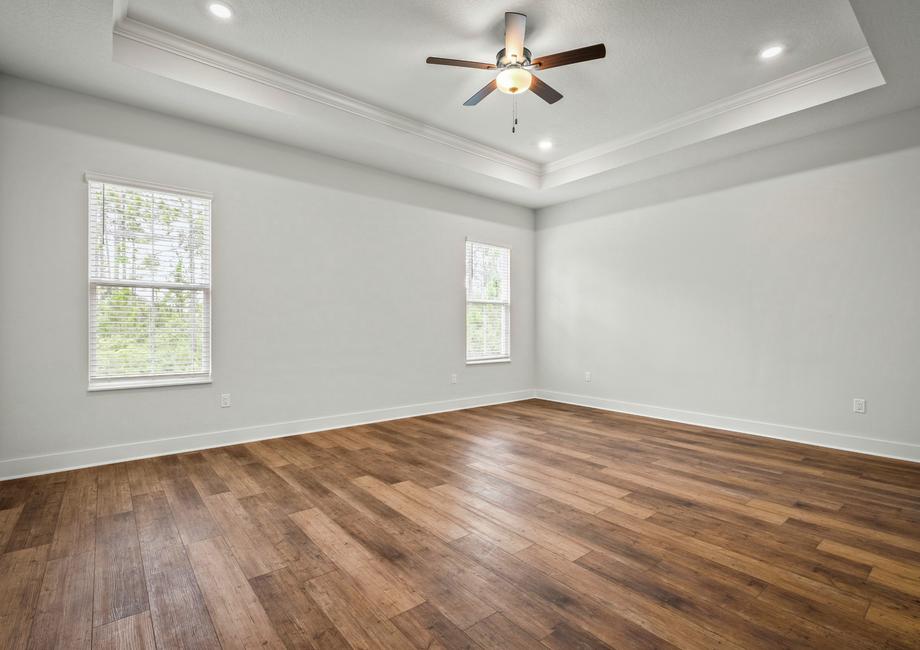 The master bedroom has gorgeous wood floors.