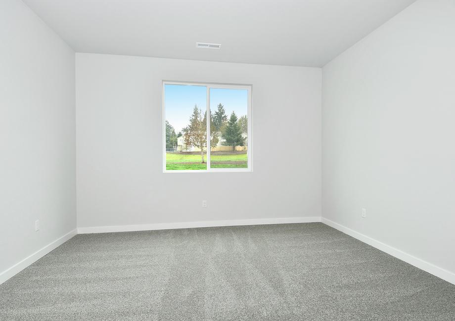 The master bedroom has a large window and is spacious.