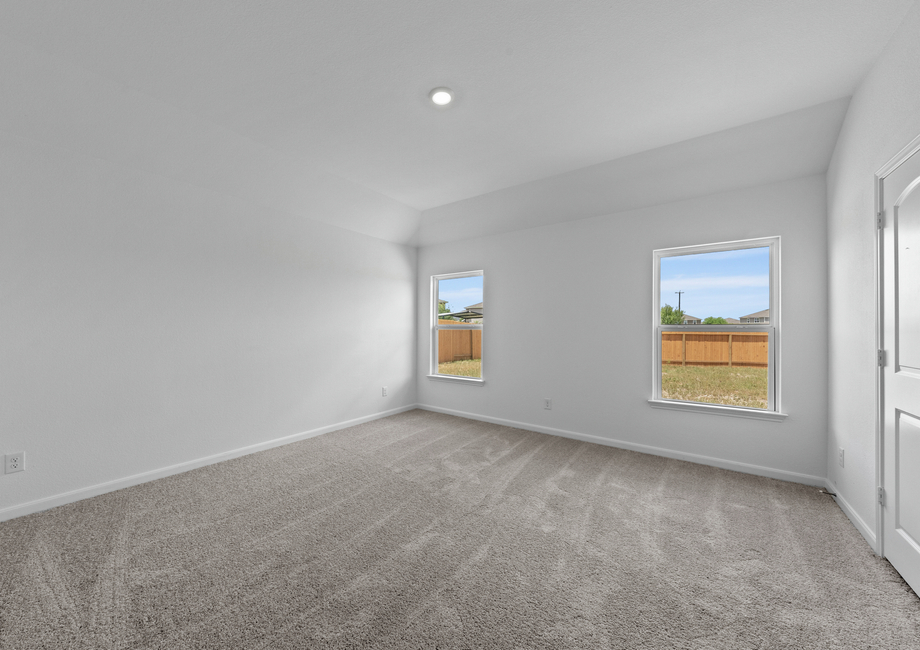 Large master bedroom with two windows for plenty of natural light