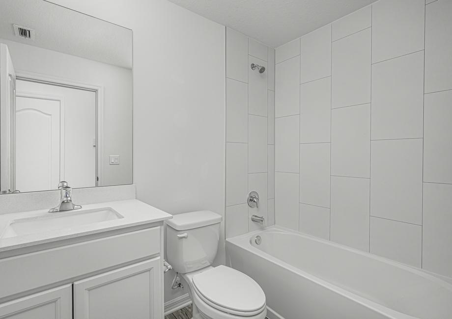 A spacious secondary bathroom