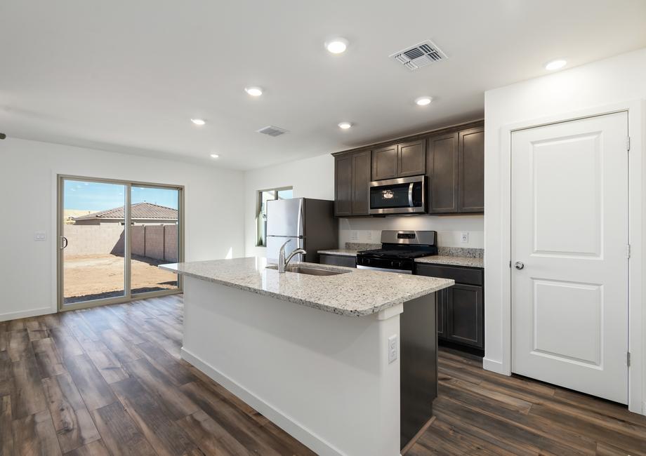 The kitchen has granite countertops and wood cabinetry.