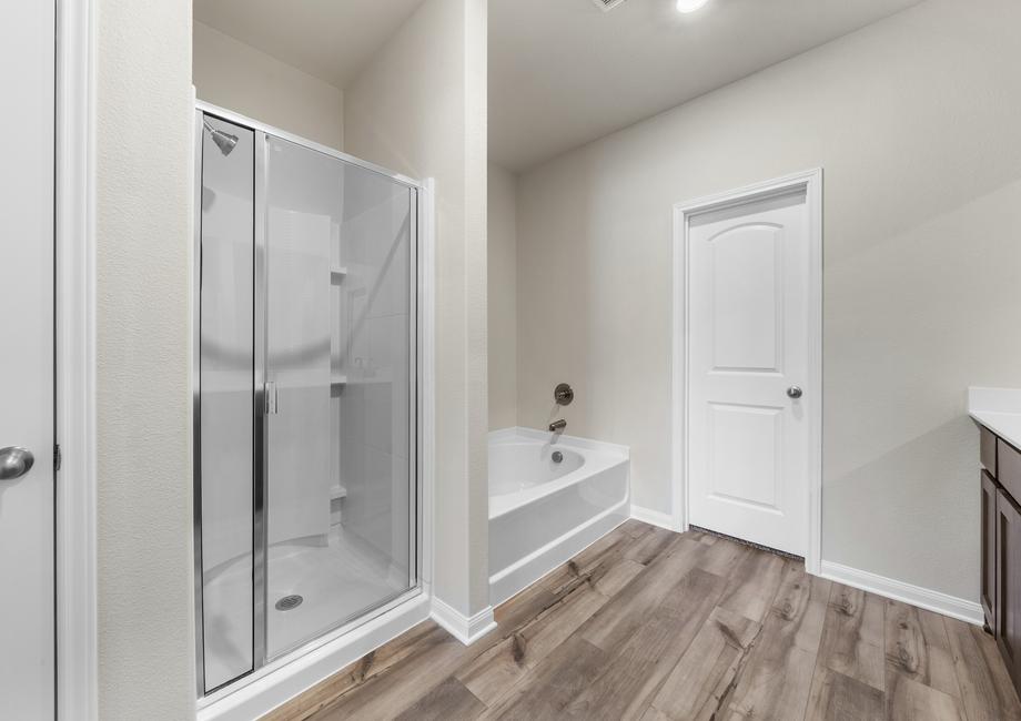 The master bathroom of the Cypress has a large glass, walk-in shower and gorgeous garden tub.