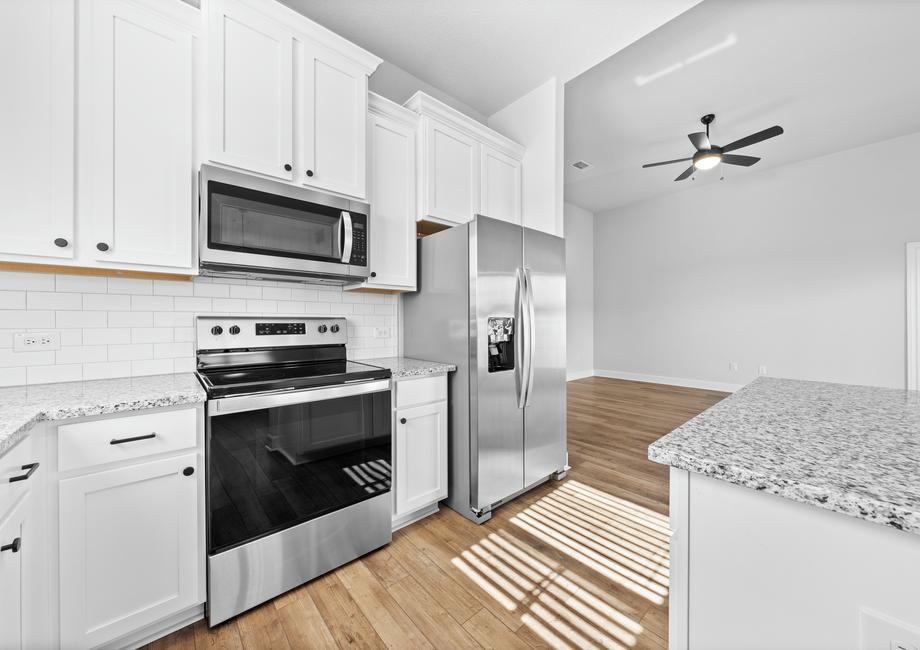 <p>Stainless Steel Whirlpool appliances nestled amongst marble countertops and white cabinetry. </p>