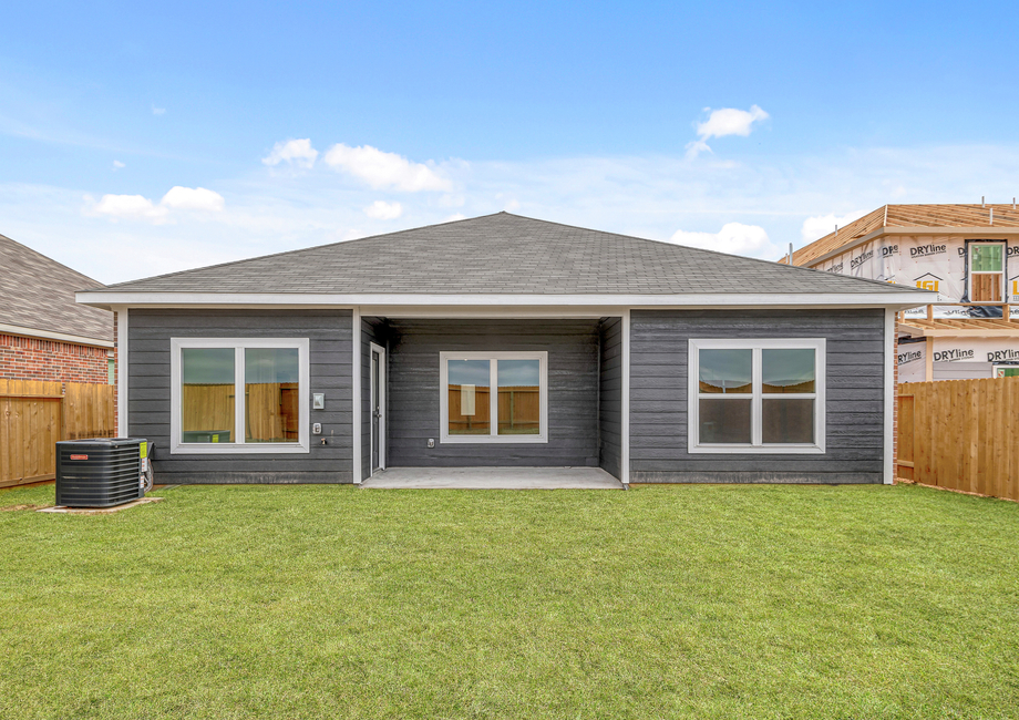 A spacious backyard with a covered patio