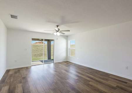 The family room is spacious and has a sliding glass door leading onto the back patio