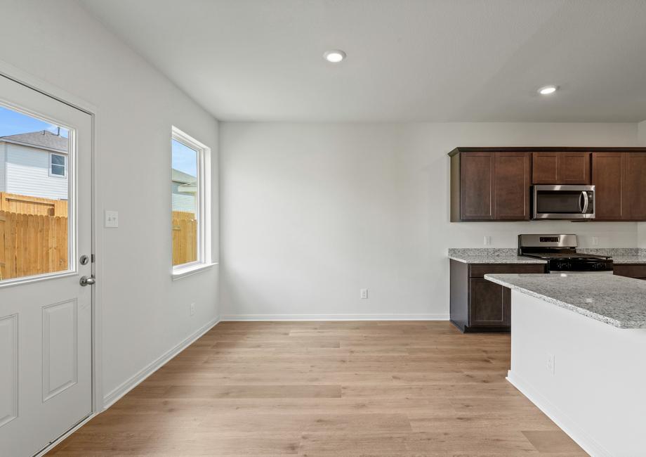 The dining room sits right off of the kitchen and has a large window.