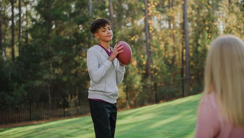 Kids playing football together