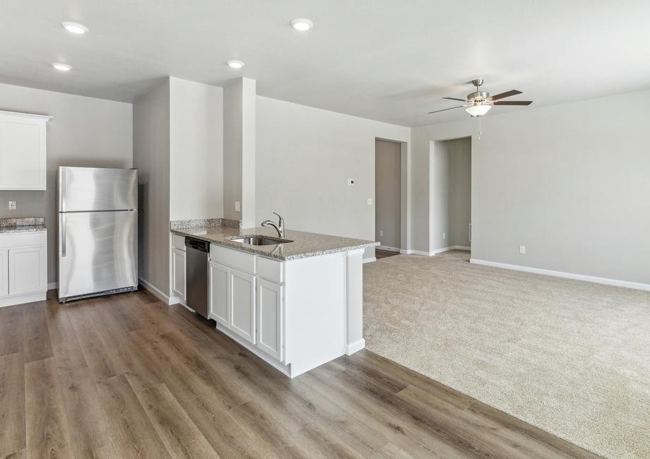 The kitchen of the Chatfield has white wood cabinets and granite countertops.