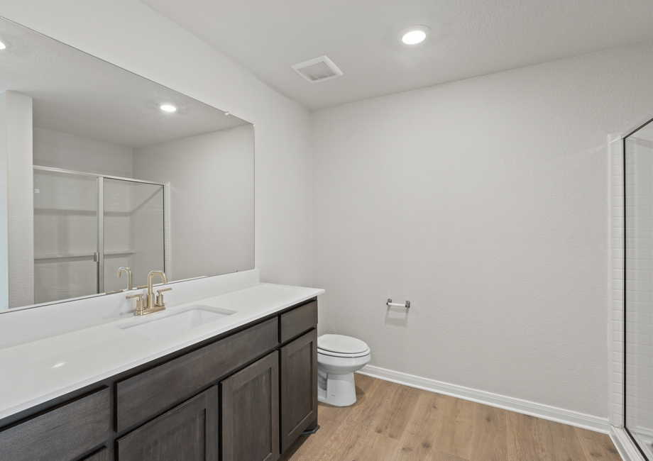 The master bathroom has a large vanity with lots of counterspace.