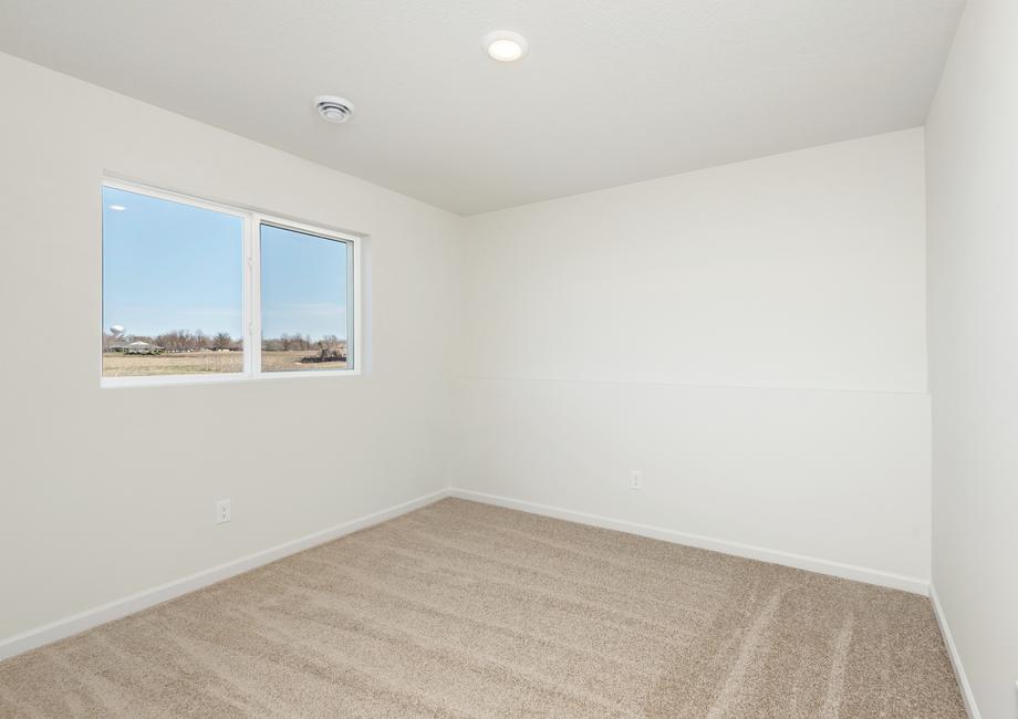 This spacious secondary bedroom in the Ramsey floor plan is great for kids or guests