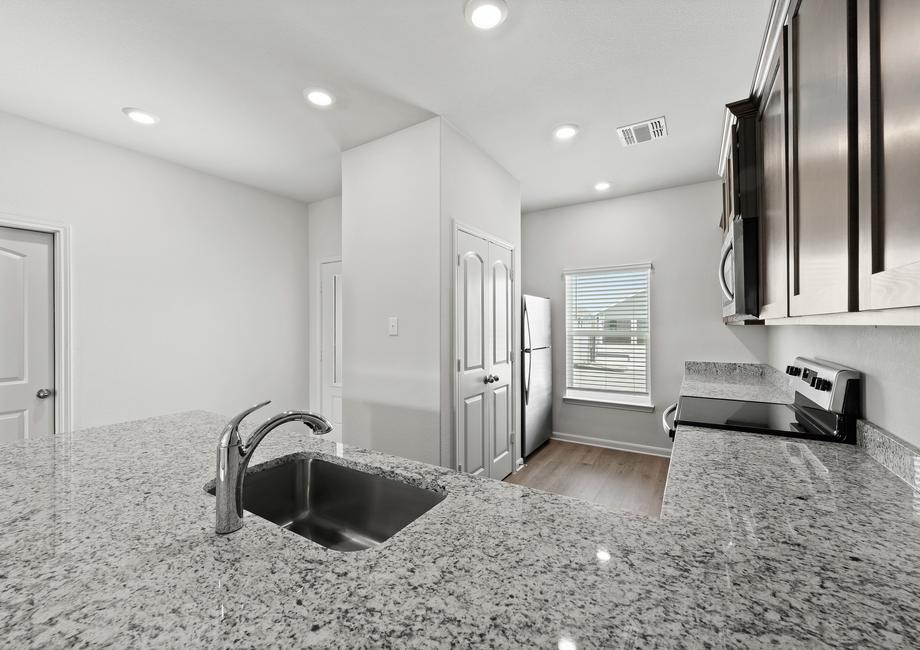 The kitchen of the Driftwood has sprawling granite countertops.