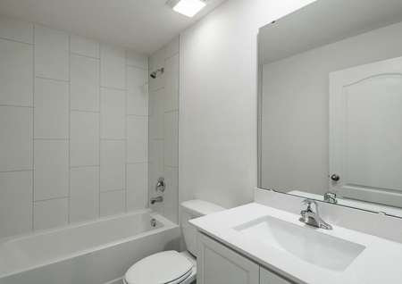 The guest bathroom has a spacious vanity, ready for your guests