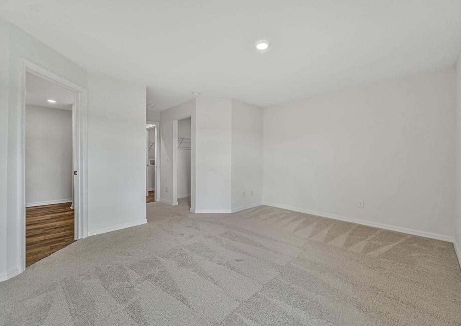 The spacious master bedroom with attached bathroom and walk-in closet