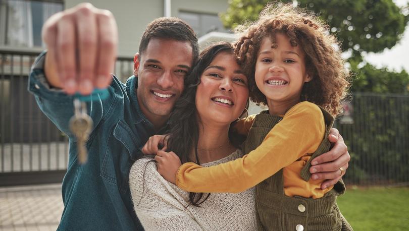 <p>Family in front of home with their keys.</p>