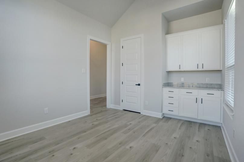 Study off of the entry with extra cabinet space paired with a storage closet.