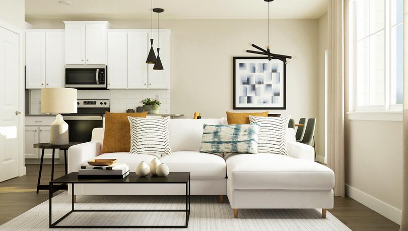 Rendering of living room with a white
  sectional and coffee table. The kitchen can be seen behind the couch.