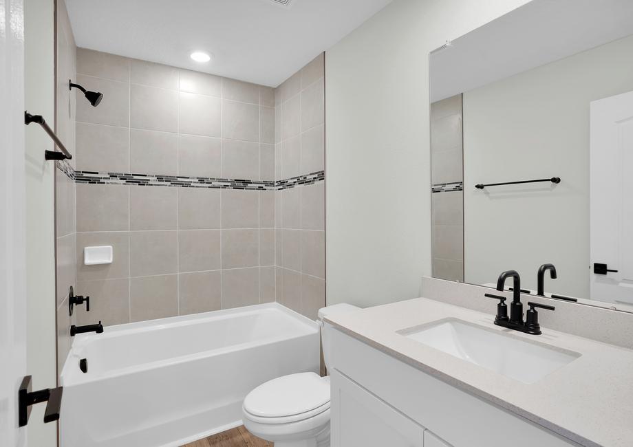 The third bathroom has a spacious vanity and tub