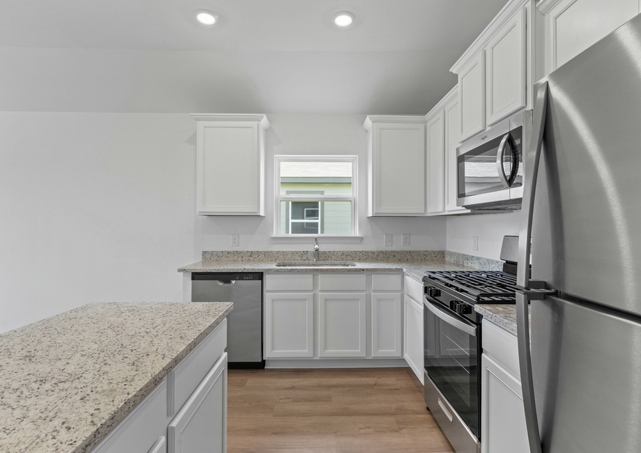 Kitchen with grey granite countertops and stainless steel appliances