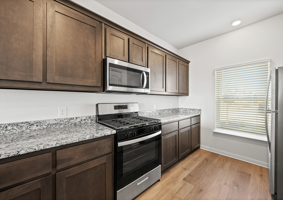 The kitchen has beautiful wood cabinetry.