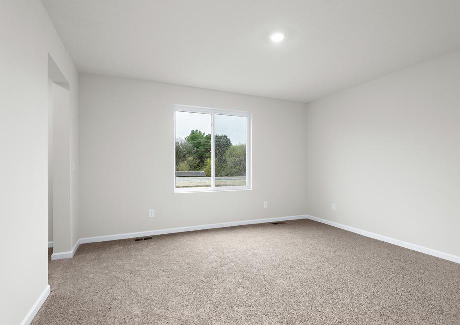 The master bedroom is spacious and has a large window.