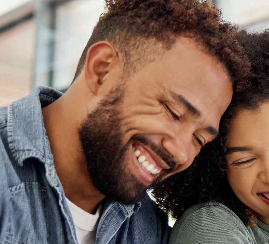 Young happy couple going through documents and using a digital tablet at a table together at home.