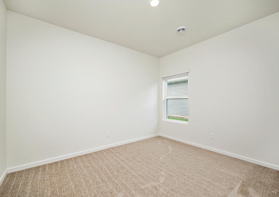 The guest bedroom is spacious and has plenty of natural light